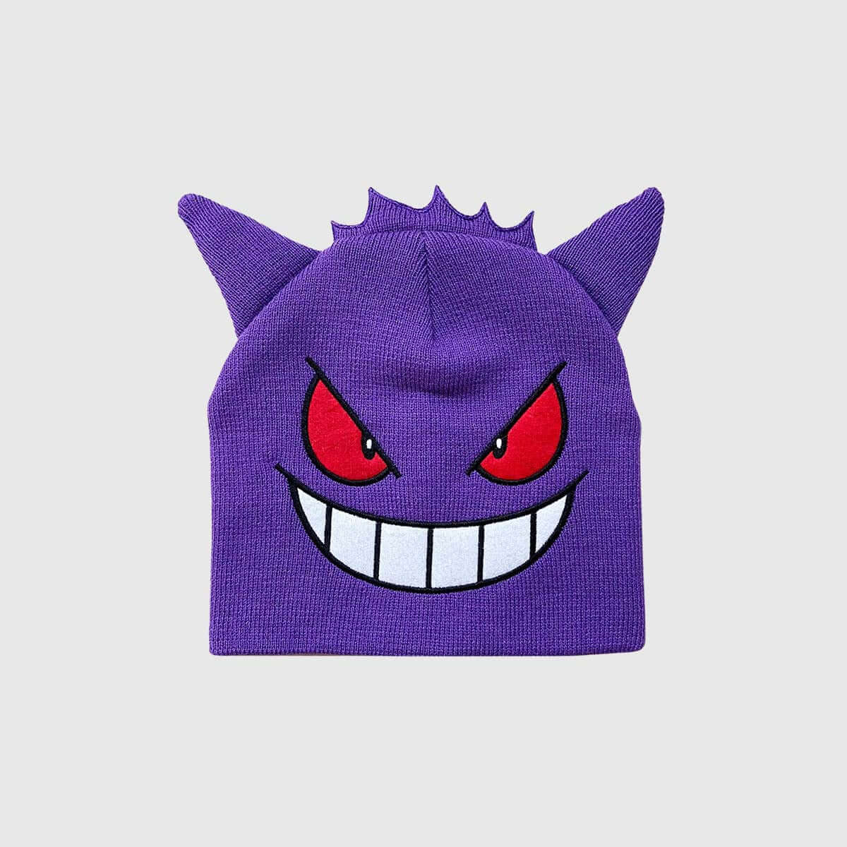 Purple knit hat with cartoon monster design featuring red eyes and a big grin, perfect for playful winter wear.