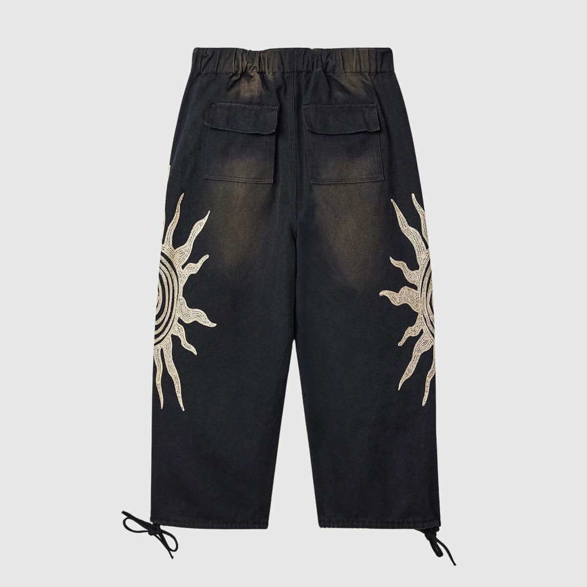 Sun graphic drawstring pants in black with unique sun designs, featuring a relaxed fit and adjustable waist for comfort.