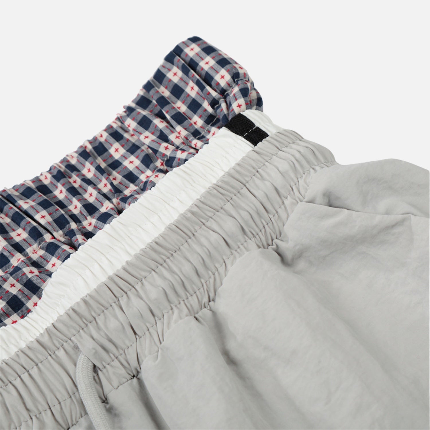 Pantalones de doble cintura con efecto de doble capa